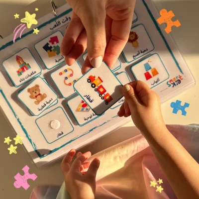 A girl holding a train card on the playtime page in My Arabic Words