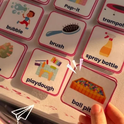 A girl holding a ball pit card from the English games and activities cards