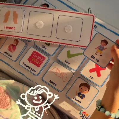 A girl building the sentence “I want to go to” with English communication cards