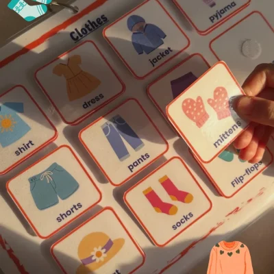A girl holding a mittens card in the English clothing vocabulary activity