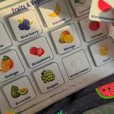 A girl matching a watermelon card on the English fruit and vegetables page