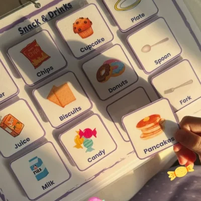 A girl holding a pancakes card from the English snacks and drinks cards