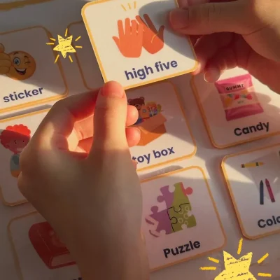 A girl placing a “high five” card in the English games vocabulary activity