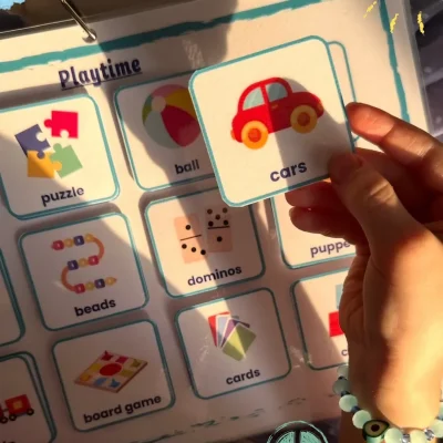 A girl holding a cars card on the playtime page in My English Words